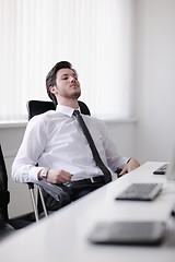 Image showing tired and depresed young business man at office