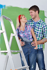 Image showing happy couple paint wall at new home