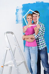 Image showing happy couple paint wall at new home