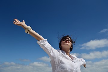 Image showing young woman with spreading arms to sky