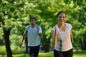 Image showing Young couple jogging