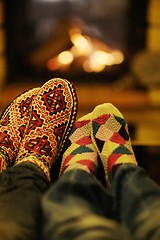 Image showing Young romantic couple relax on sofa in front of fireplace at hom