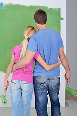 Image showing happy couple paint wall at new home