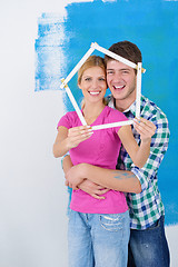 Image showing happy couple paint wall at new home