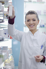 Image showing pharmacist chemist woman standing in pharmacy drugstore