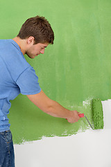 Image showing happy couple paint wall at new home