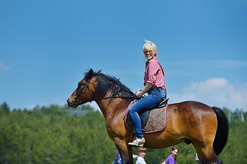 Image showing happy woman  ride  horse