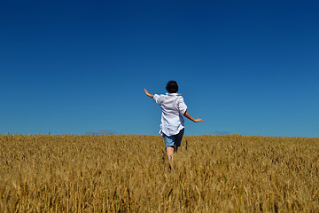 Image showing young woman in wheat field at summer