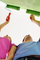 Image showing happy couple paint wall at new home