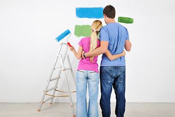 Image showing happy couple paint wall at new home