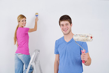 Image showing happy couple paint wall at new home