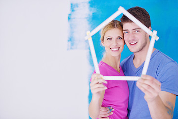 Image showing happy couple paint wall at new home