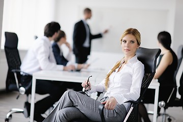 Image showing business woman with her staff in background