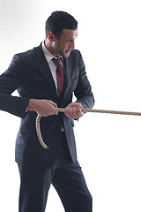 Image showing business man with rope isolated on white background