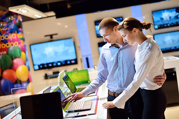 Image showing Young couple in consumer electronics store