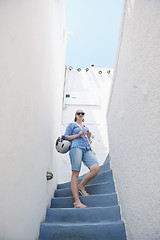 Image showing Greek woman on the streets of Oia, Santorini, Greece