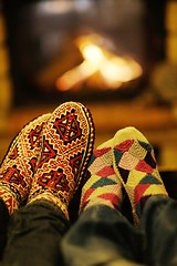 Image showing Young romantic couple relax on sofa in front of fireplace at hom