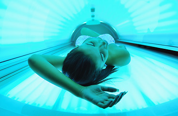 Image showing Beautiful young woman tanning in solarium