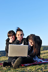 Image showing group of teens working on laptop outdoor