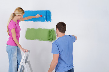 Image showing happy couple paint wall at new home