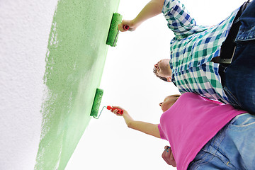 Image showing happy couple paint wall at new home