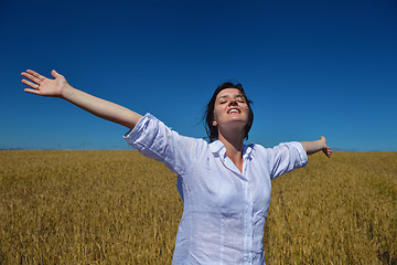 Image showing young woman in wheat field at summer