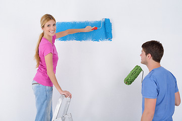 Image showing happy couple paint wall at new home