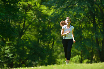 Image showing Young beautiful  woman jogging at morning in park