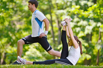 Image showing Couple doing stretching exercise  after jogging