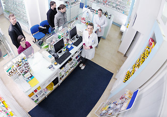 Image showing pharmacist suggesting medical drug to buyer in pharmacy drugstor