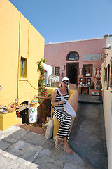 Image showing Greek woman on the streets of Oia, Santorini, Greece