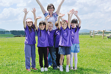 Image showing happy kids group with teacher in nature