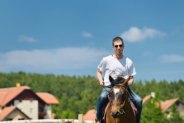 Image showing man ride horse