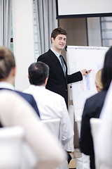 Image showing Young  business man giving a presentation on conference