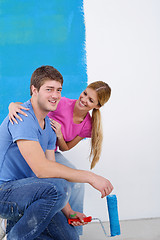 Image showing happy couple paint wall at new home