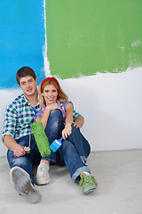 Image showing happy couple paint wall at new home