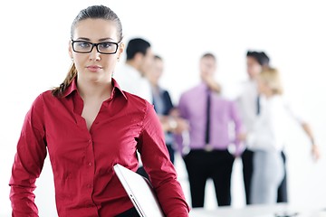 Image showing business woman standing with her staff in background