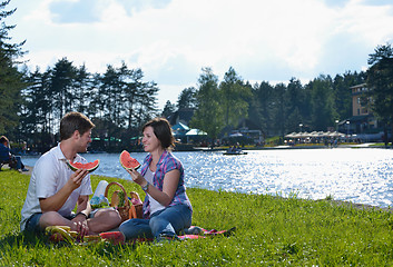 Image showing happy young couple having a picnic outdoor