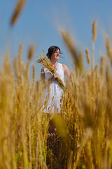 Image showing young woman in wheat field at summer