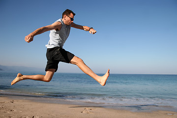 Image showing Man jumping on the beach