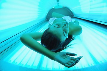 Image showing Beautiful young woman tanning in solarium