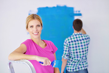 Image showing happy couple paint wall at new home