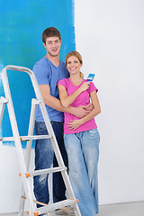 Image showing happy couple paint wall at new home