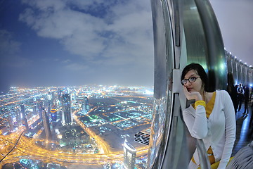 Image showing beautiful woman portrait with big city at night in background