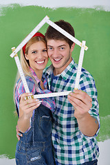 Image showing happy couple paint wall at new home