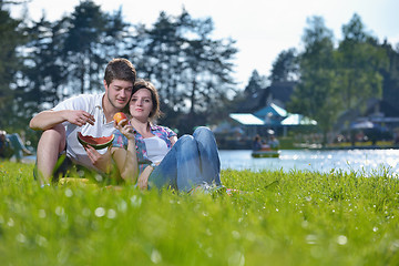 Image showing happy young couple having a picnic outdoor