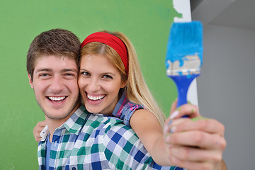 Image showing happy couple paint wall at new home