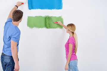 Image showing happy couple paint wall at new home