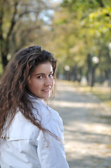 Image showing brunette Cute young woman  posing outdoors