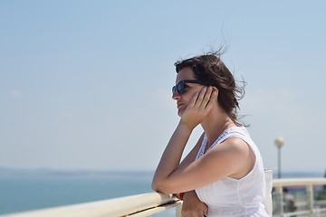 Image showing young woman with spreading arms to sky